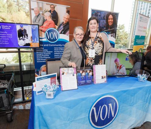 VON staff standing behind table at conference