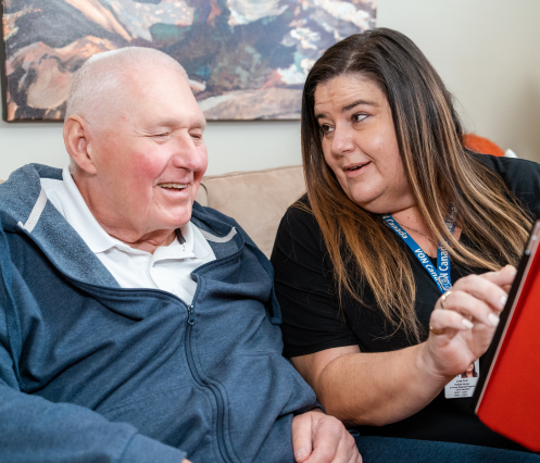Two people looking at a tablet together