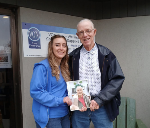 Kayla Stock and Tom Quinn holding photo of Helen 2024 