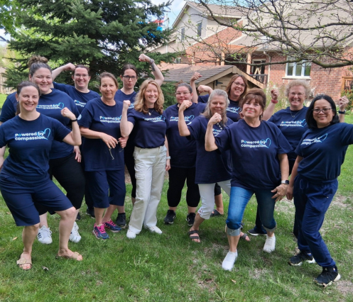 A group of VON staff posed outdoors wearing their VON Powered by Compassion t-shirts.