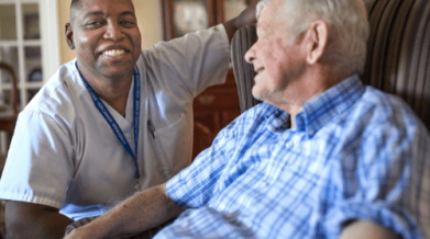A VON Staff member (male) with a senior male client in their home.