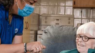 homemaker opens a water bottle for client