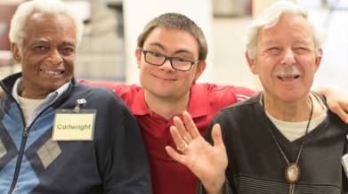 Three people in a group photo excited to buy raffle tickets
