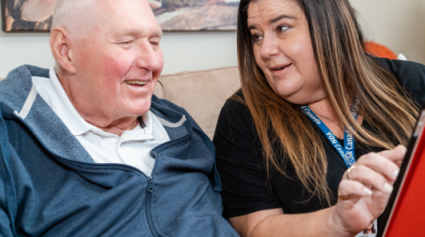 Two people looking at a tablet together