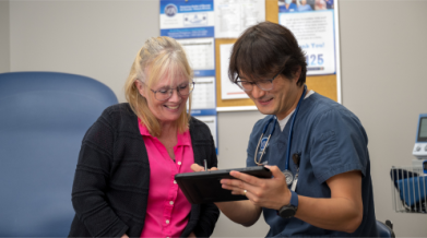 Two people looking at a tablet together