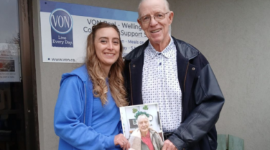Kayla Stock and Tom Quinn holding photo of Helen 2024 