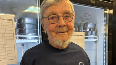 Photo of Carlton infront of a freezer for Meals