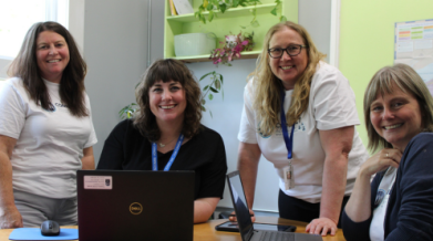 Photo of four staff members with technology