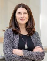 Image of Roxanne Anderson wearing a black shirt, necklace and grey knit cardigan 