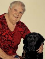 Woman smiling in a photo with her dog